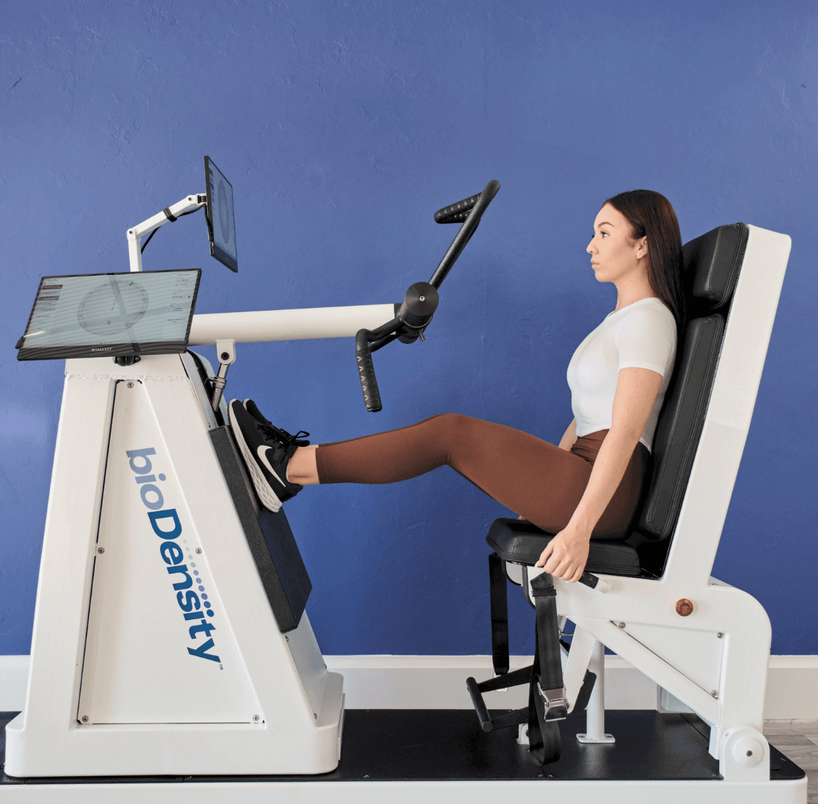 Woman using BioDensity osteogenic loading machine